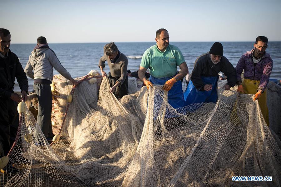 Iranian fishermen work at the Caspian sea beach near Anzali Port, northern Iran, on March 27, 2017. (Xinhua/Ahmad Halabisaz) Iranian fishermen work at the Caspian sea beach near Anzali Port, northern Iran, on March 27, 2017. (Xinhua/Ahmad Halabisaz)